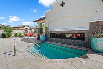 A swimming pool in front of a house with a pool
